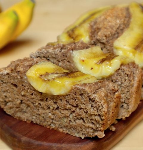 vegan chai banana bread slices on a wooden board